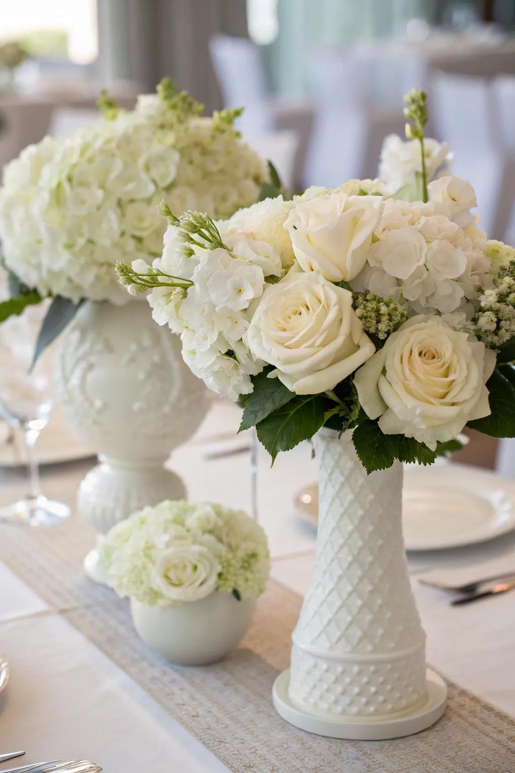 White flowers serve as an impressive focal point for a monochromatic ivory-themed meal setting.