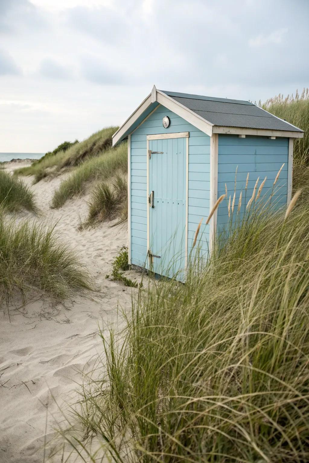 A seaside outbuilding adorned in a peaceful marine color palette for an invigorating coastal design.