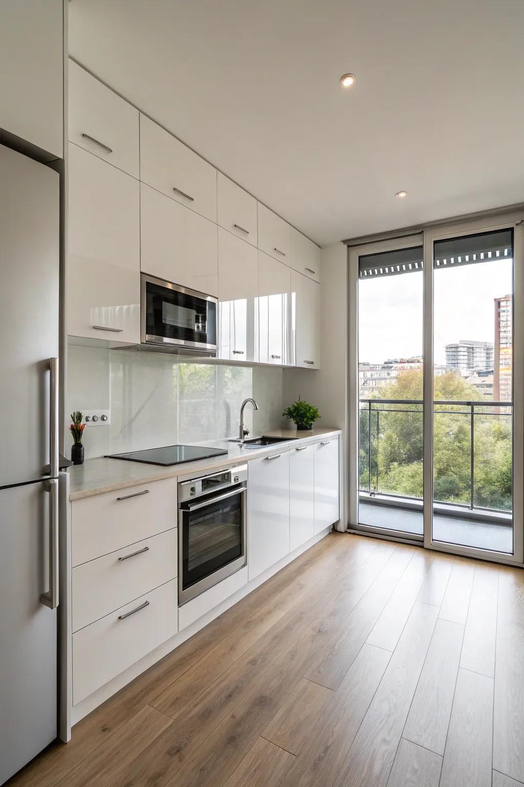 A minimalist galley kitchen featuring glossy cabinets and stainless steel appliances.