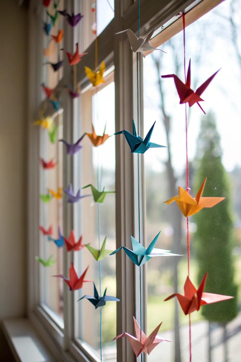 Paper birds floating in sunlight.