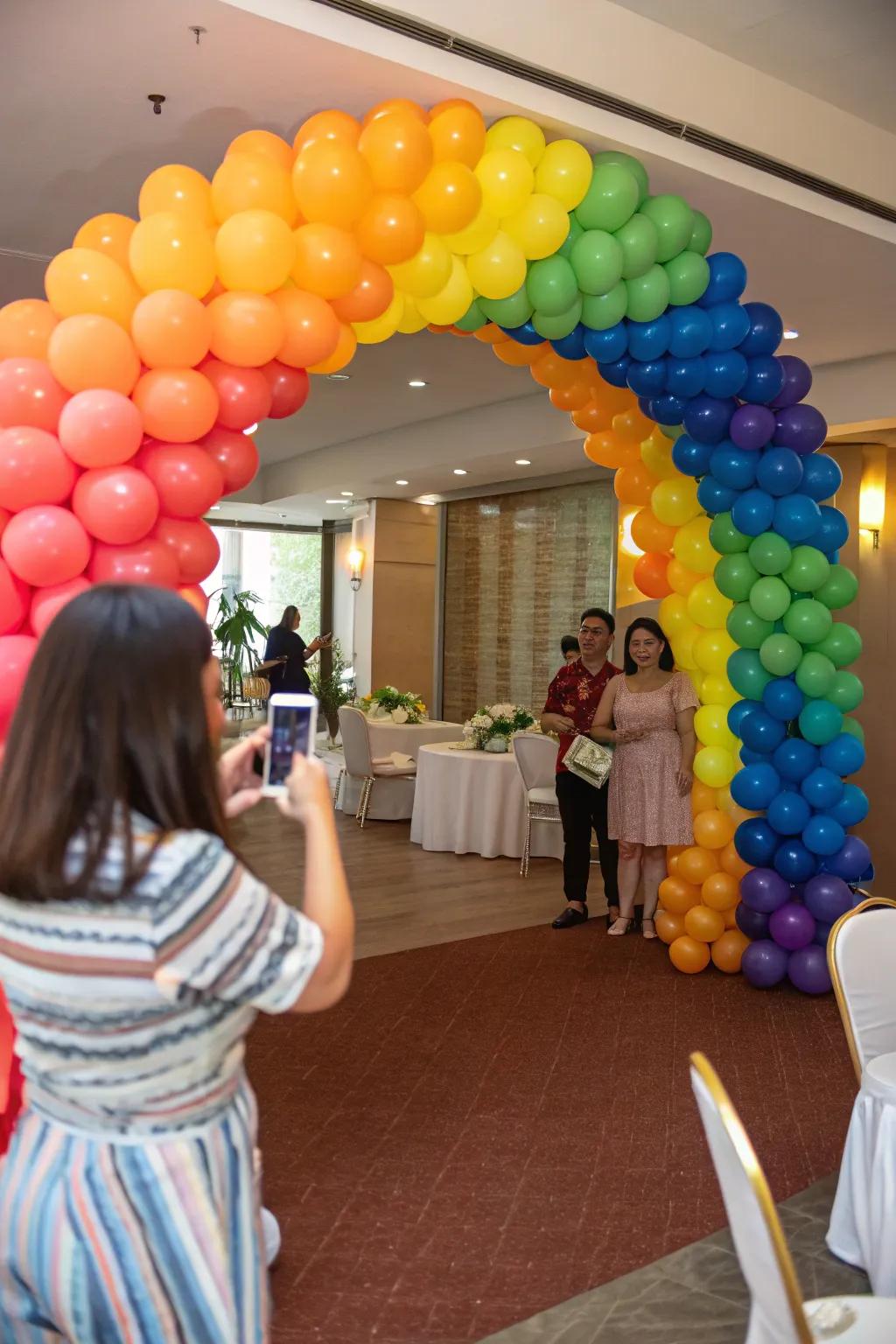 Guests loving the dynamic spectral balloon arch at a party entrance.