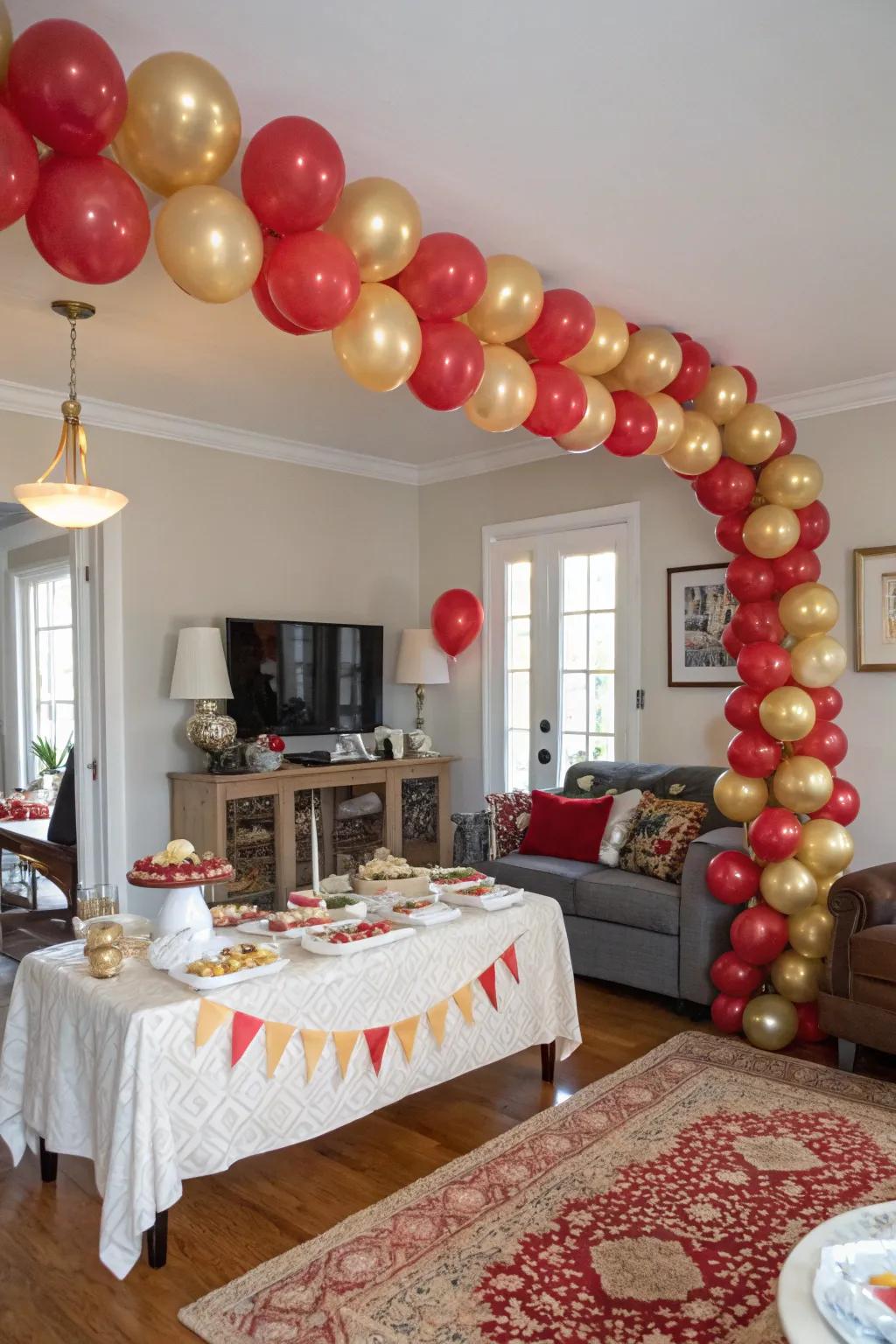 An eye-catching crimson and gilded balloon arch establishes a festive ambiance.