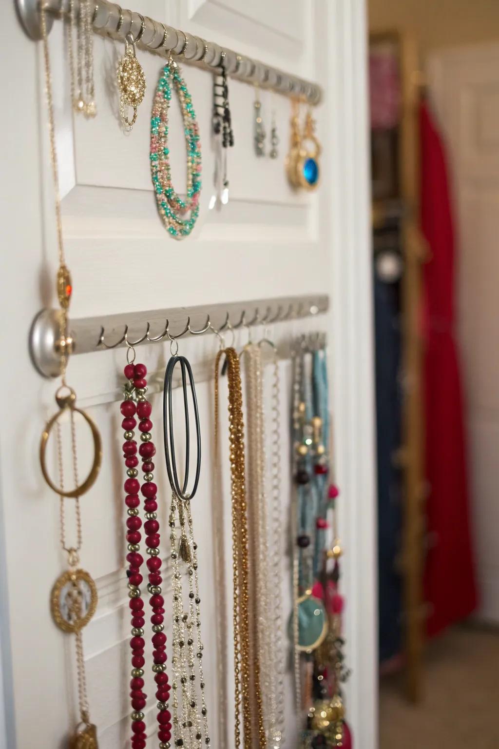 Space-efficient jewelry organizer that goes over a door