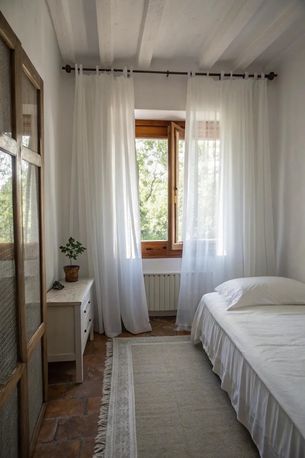 Ivory drapes aid in rendering this petite sleeping quarter appear larger.
