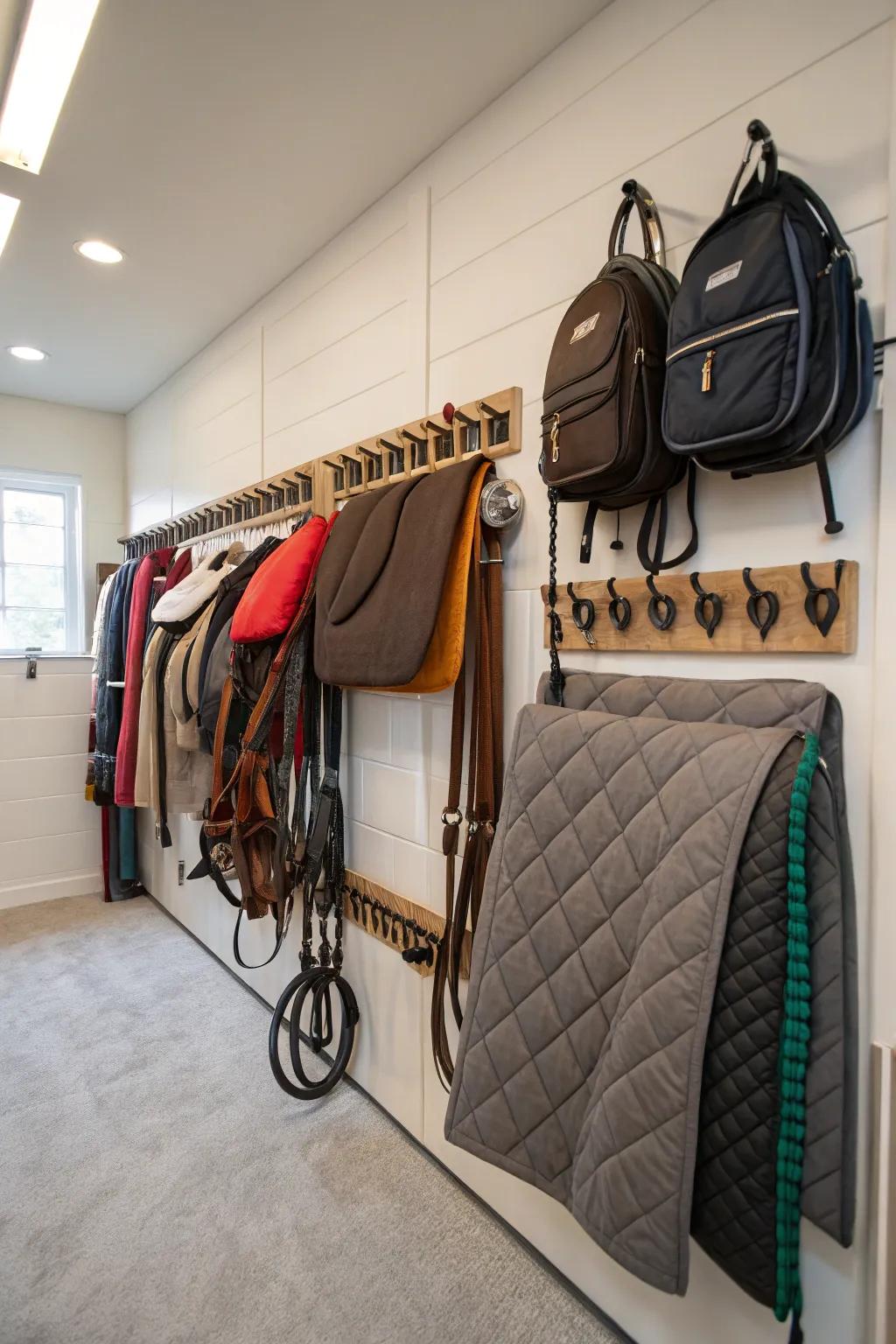 Mounted blanket hangers in a tack room for efficient storage.