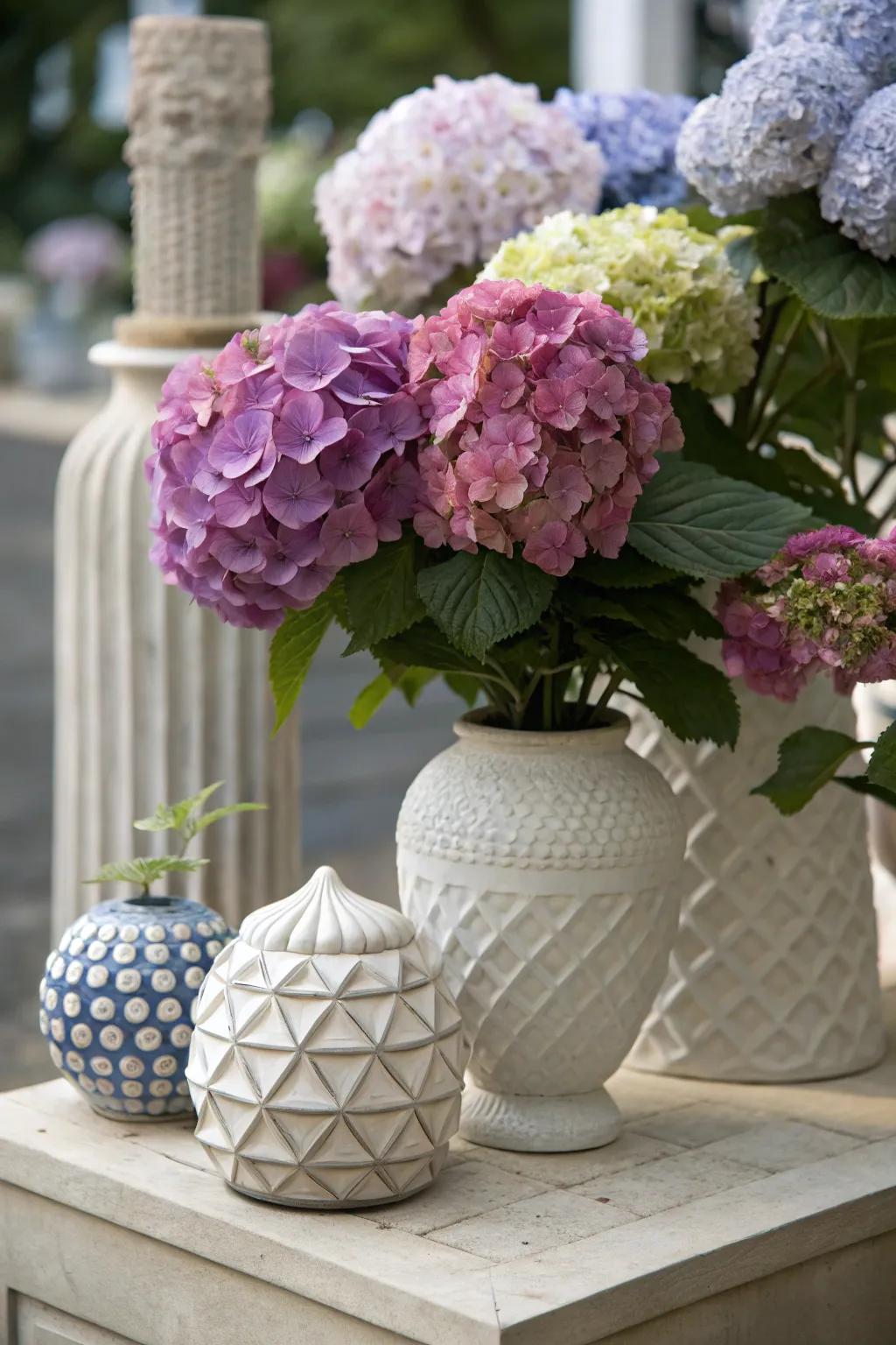 Creative composition of hydrangeas alongside sculptural pieces.