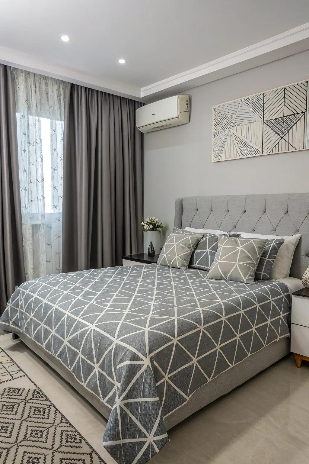 Geometric patterns add a modern twist to the grey bedroom.