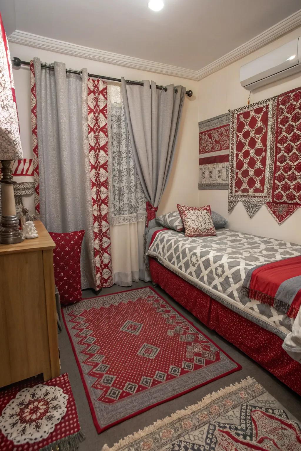 A compact bedroom with mixed patterns in fabrics appending appeal to the scarlet and charcoal scheme.