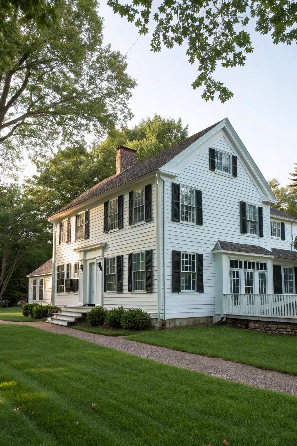 Colonial home featuring upright plank-and-strip siding.