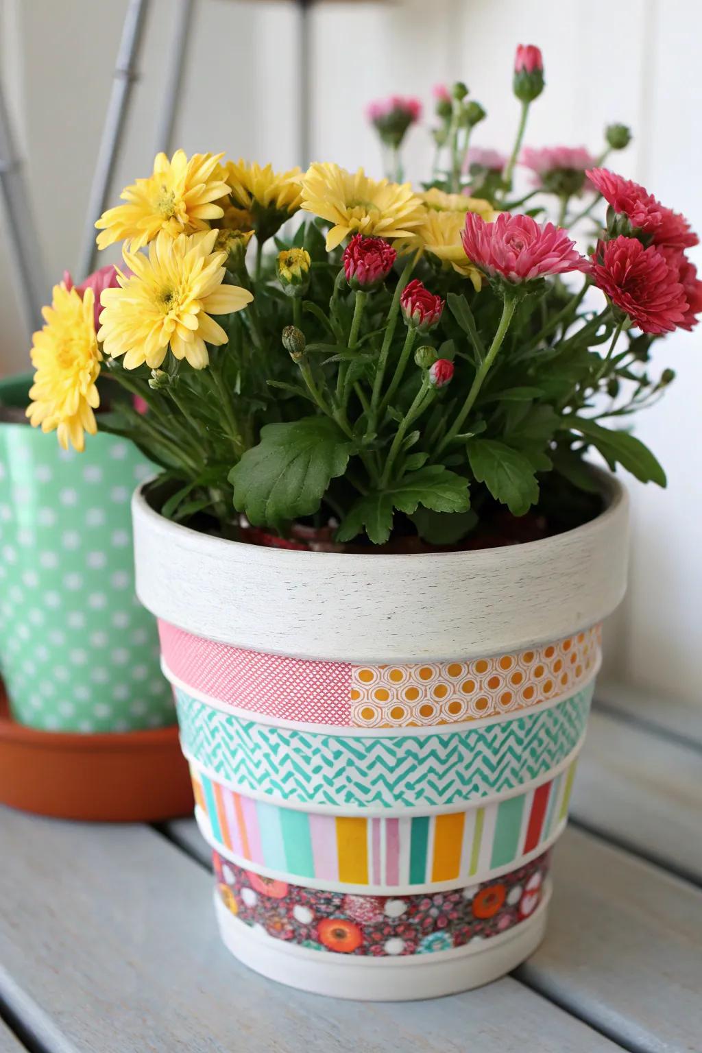 A flower pot elevated using dynamic adhesive craft strip designs.
