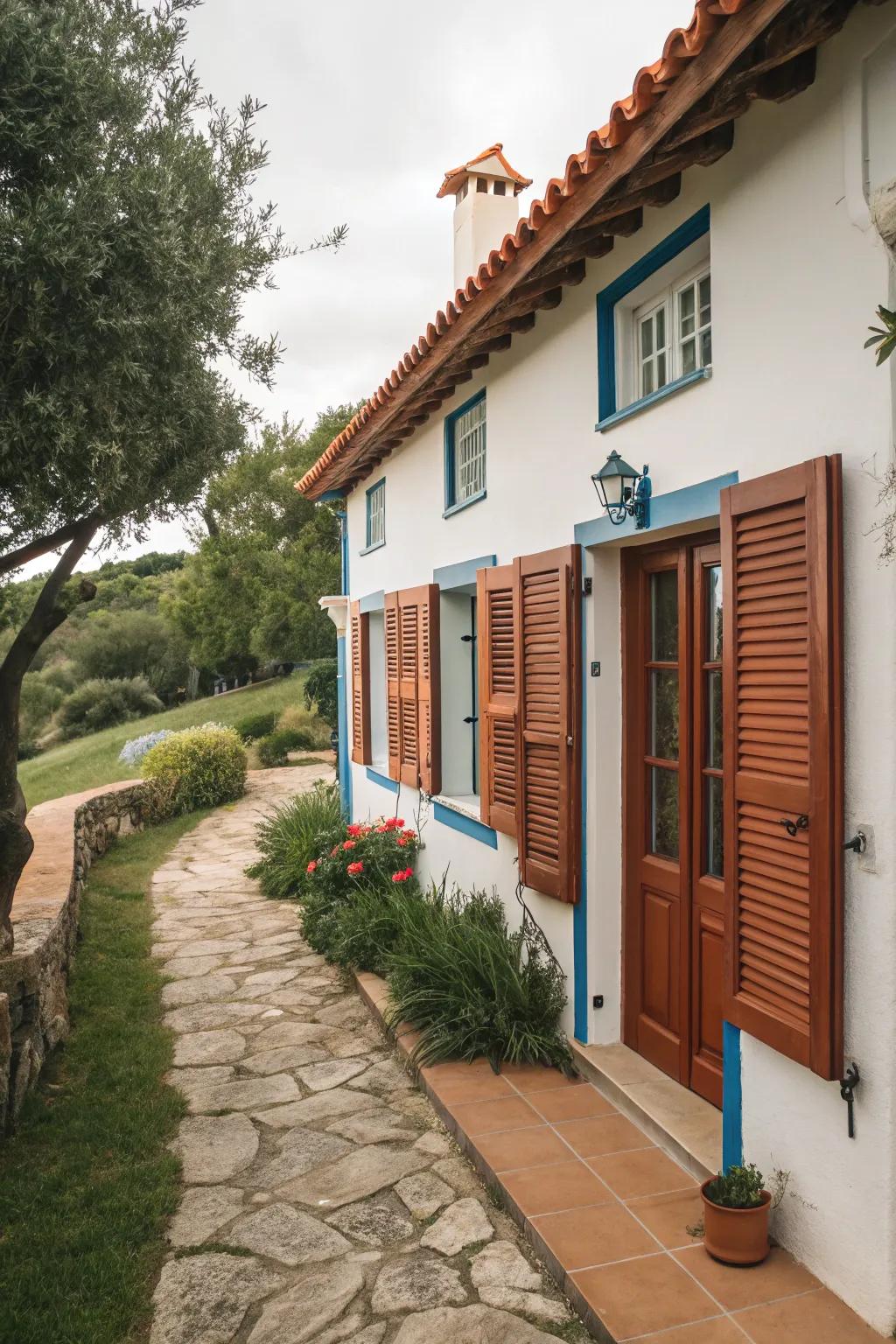 Mediterranean-style house featuring terracotta shutters.