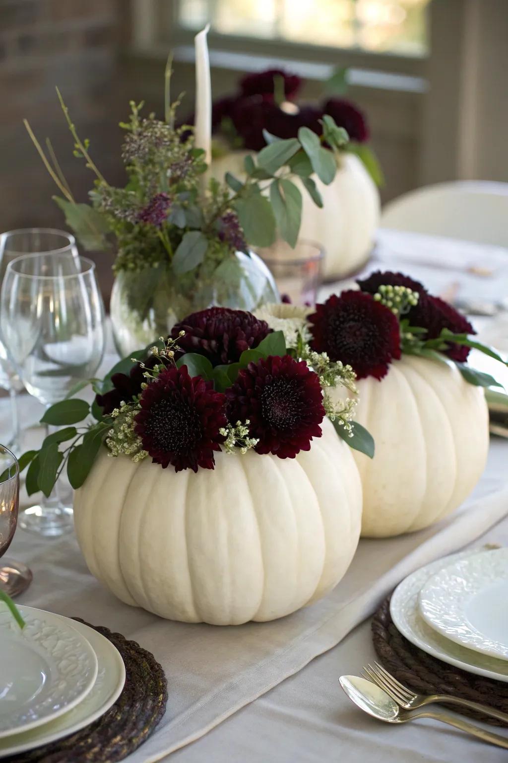 Alabaster pumpkins filled with flowers fashion a unique, thematic centerpiece.