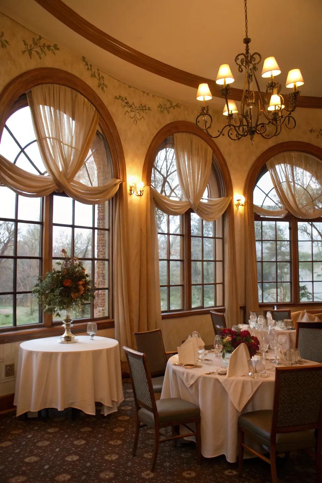An amorous dining space showcases fabric valances on arched windows.