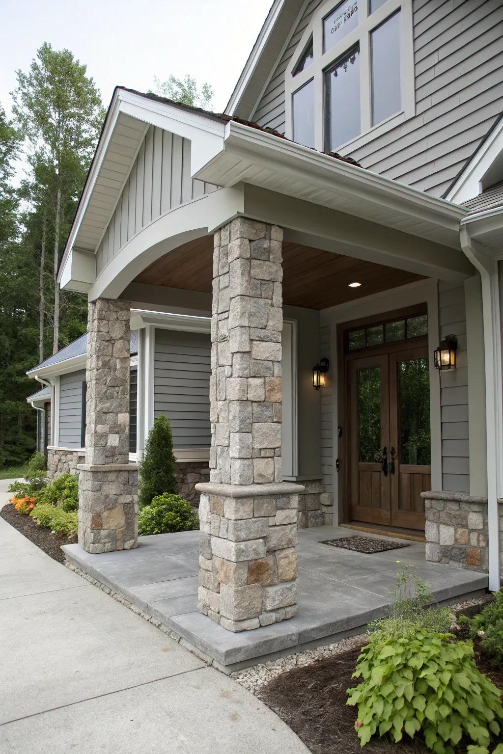 Majestic entryway featuring grey tones and stone columns.