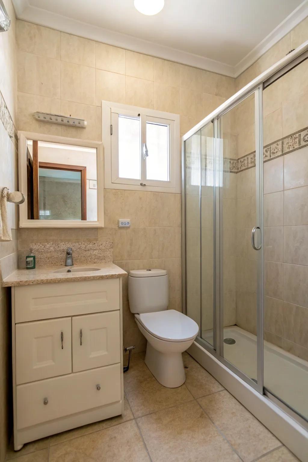 A minimalist beige bathroom detailed with crisp lines and understated ornamentation.