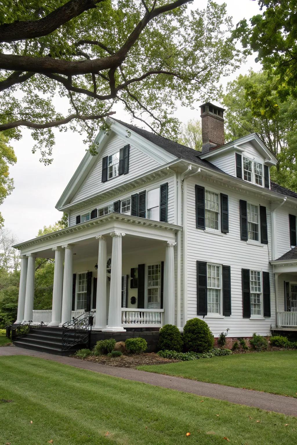 Colonial-style home featuring white siding contrasted with black trim.