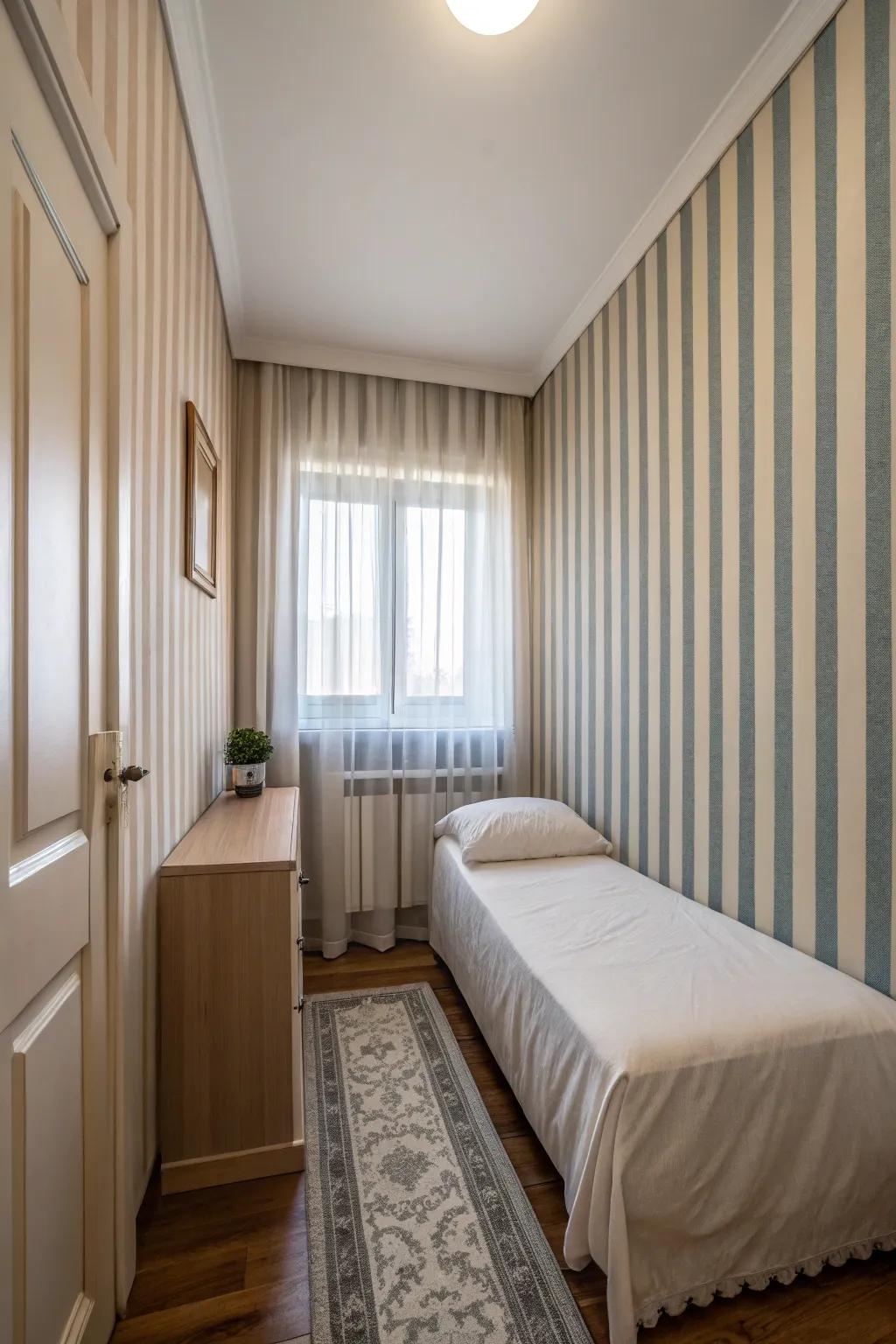Vertical stripes inject height and visual interest in a slender bedroom.