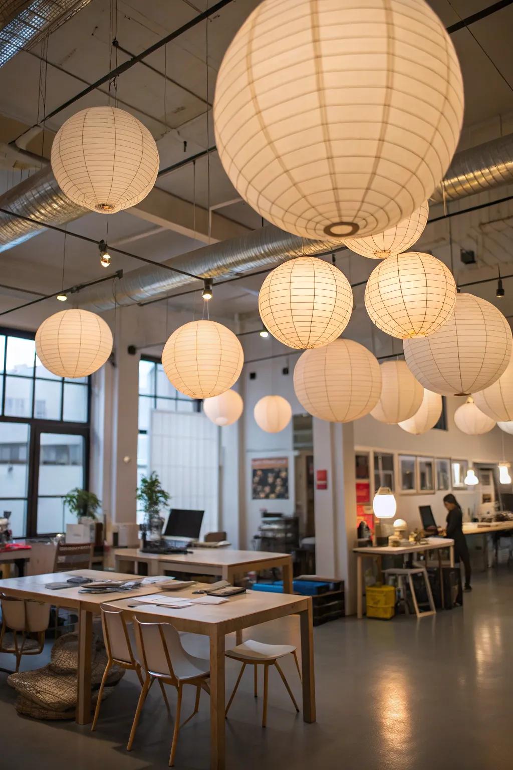 Rice paper lanterns create a fun and whimsical sensation in this creative work space.