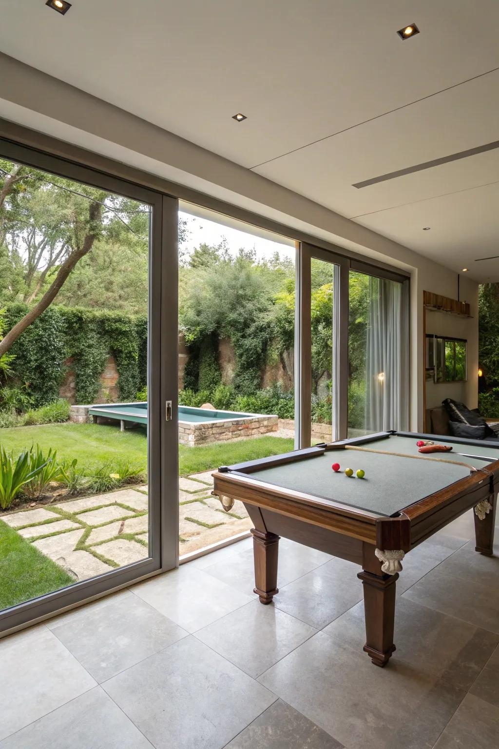 An indoor-outdoor living area featuring a game table and access to a garden.