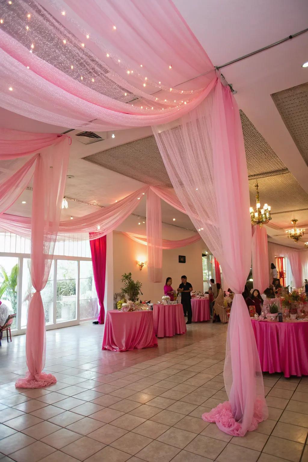 Pink tulle draping creates a whimsical and dreamy party vibe.