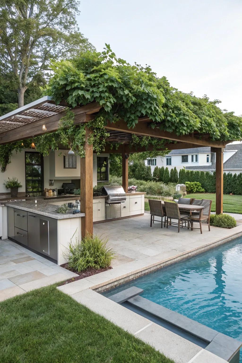 Pergola with outdoor cooking area enhances poolside hosting.