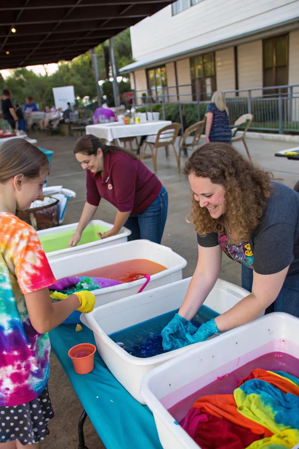 Guests diving into a tie-dye station, making cool spectral designs.