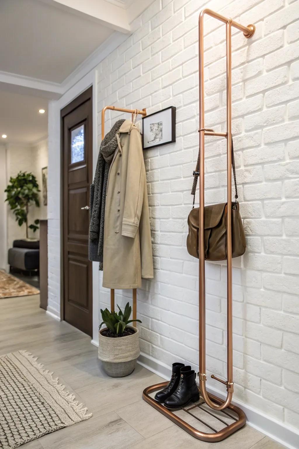 A brass conduit coat rack introduces elegance and warmth to this chic entryway.