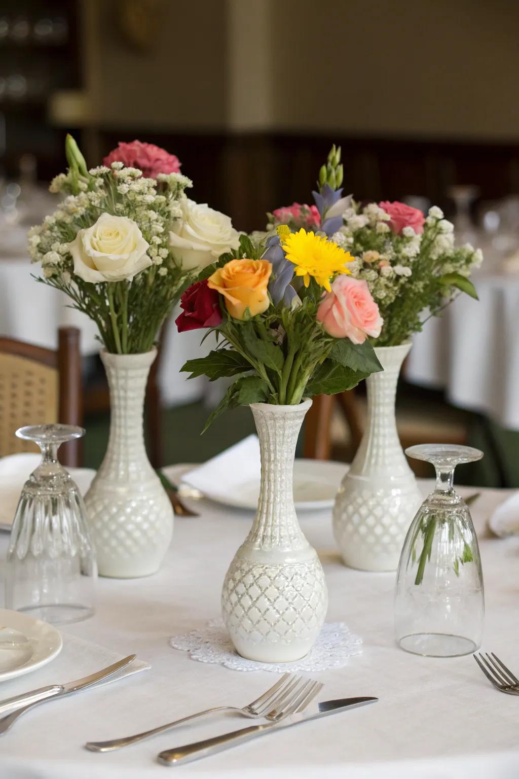 A dining table featuring a trio of flower containers arranged elegantly.