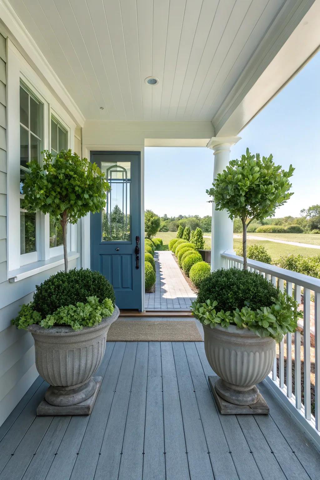 A side porch featuring symmetrical planters framing a centered door.